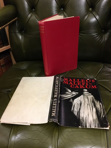 Malleus Maleficarum book with red cover